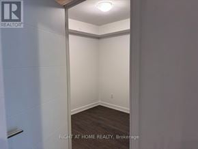 Toronto (Waterfront Communities) condo for rent - A brokerage image of an empty room with a white door.