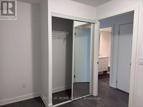 Toronto (Waterfront Communities) condo for rent - A brokerage sign is on the wall of a room with a closet.