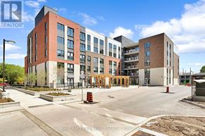 London East (East K) condo for rent - A modern building complex with a parking lot in front.