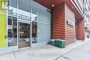 Toronto (Waterfront Communities) condo for rent - A building with a glass door entrance and a sign that says "STUDIO".