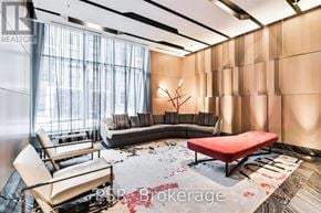 Toronto (Waterfront Communities) condo for rent - A living room with a red bench and a large window.