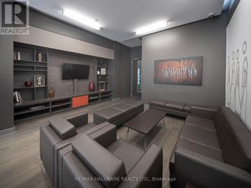 Toronto (Moss Park) condo for rent - A modern living room with brown leather furniture and a flat screen TV.