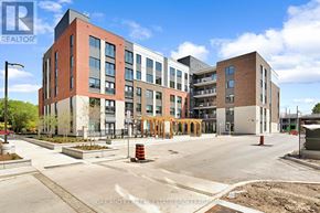 London East (East K) condo for rent - A building with a parking lot in front of it.