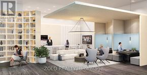 Toronto (Willowdale East) condo for rent - A modern office space with people working and a woman sitting on a chair.