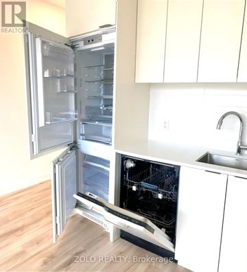 Toronto (Willowdale East) condo for rent - A white refrigerator with its door open in a kitchen.