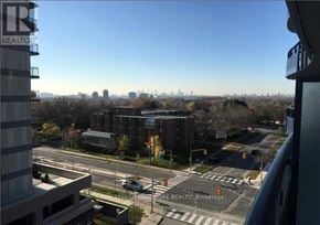 Toronto (Banbury-Don Mills) condo for rent - A view from a high-rise building looking out over a cityscape with a clear blue sky.