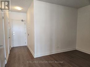 Toronto (Banbury-Don Mills) condo for rent - A white room with a door and a brokerage sign on the wall.