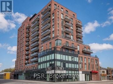 Toronto (Oakwood Village) condo for rent - A tall building with a sign that reads "PSR Brokerage" in front of it.