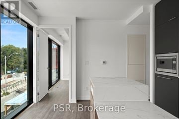 Toronto (Oakwood Village) condo for rent - A kitchen with a marble countertop and a refrigerator with a water dispenser.