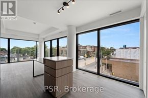 Toronto (Oakwood Village) condo for rent - A large, empty room with a view of the street outside.