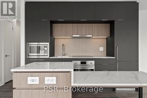 Toronto (Oakwood Village) condo for rent - A modern kitchen with a marble countertop and stainless steel appliances.