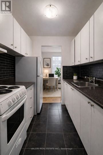 Toronto (Wexford-Maryvale) condo for rent - A modern kitchen with white cabinets and black countertops.