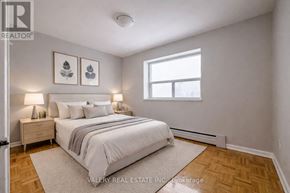 Toronto (Wexford-Maryvale) condo for rent - A bedroom with a bed, nightstands, and pictures on the wall.