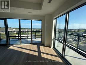 Clarington (Bowmanville) condo for rent - A room with a view of a residential area through large windows.