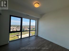 Clarington (Bowmanville) condo for rent - A room with a large window overlooking a residential area.