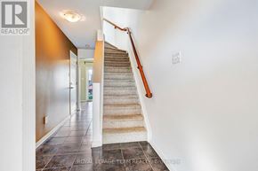 Ottawa townhouse for rent - A staircase with a carpeted runner and wooden handrail.