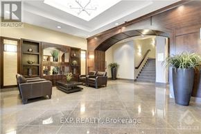 Ottawa condo for rent - A spacious lobby with a staircase and a potted plant.