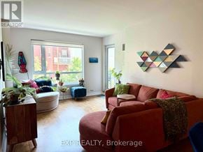Ottawa condo for rent - A living room with a red couch and a wooden side table.