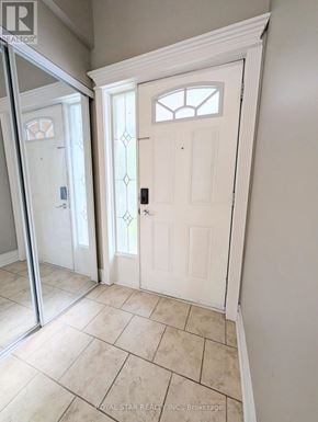 Ottawa townhouse for rent - A white door with a glass window is in a room with tiled flooring.