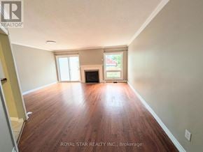 Ottawa townhouse for rent - A room with wooden floors and a fireplace is for sale.
