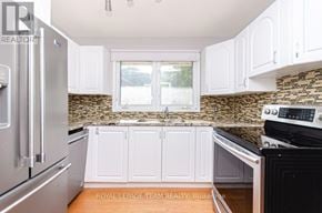 Ottawa apartment for rent - A room with a bed and a window overlooking a garden.