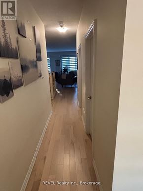 Thorold (Rolling Meadows) townhouse for rent - A hallway with wood floors and pictures on the wall.