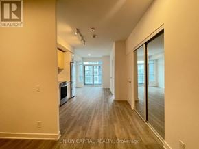 Vaughan (Brownridge) condo for rent - A spacious room with wooden flooring and a large window.