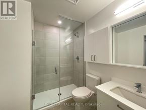 Vaughan (Brownridge) condo for rent - A white bathroom with a glass shower door and a toilet.