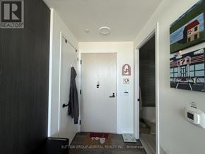 Vaughan (Vaughan Corporate Centre) condo for rent - A hallway with a door on the left and a door on the right.