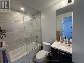 Vaughan (Vaughan Corporate Centre) condo for rent - A bathroom with a glass shower enclosure and a toilet.