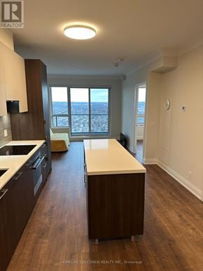 Markham (Unionville) condo for rent - A kitchen with dark wood cabinets and a white countertop.