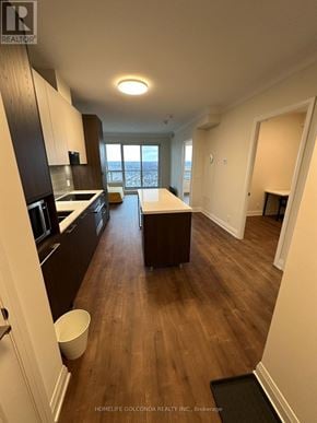 Markham (Unionville) condo for rent - A kitchen with dark wood floors and white walls.