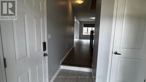 Caledon apartment for rent - A hallway with white doors and a wooden floor.
