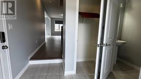 Caledon apartment for rent - A hallway with a door on the left and a bathroom on the right.