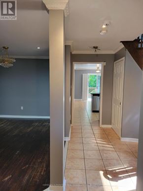 Mississauga (Lisgar) apartment for rent - A hallway with a chandelier and a ceiling fan.