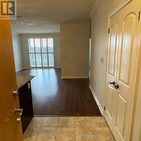 Milton (Om Old Milton) condo for rent - A room with wooden floors and white walls, with a door on the right side.
