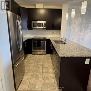 Milton (Om Old Milton) condo for rent - A kitchen with a refrigerator, microwave, oven, and sink.