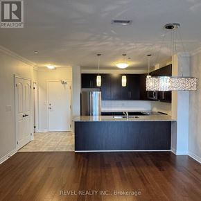Milton (Om Old Milton) condo for rent - A kitchen with dark wood cabinets and a light wood floor.