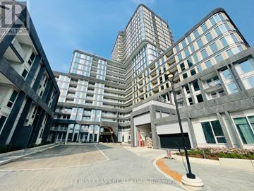 Oakville (Jm Joshua Meadows) condo for rent - A modern building complex with a clear blue sky above.