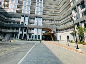 Oakville (Jm Joshua Meadows) condo for rent - A multi-story building with a glass facade and a stone facade with balconies.