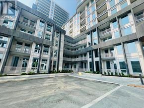 Oakville (Jm Joshua Meadows) condo for rent - A large, modern building with the words "First Class Realty Inc." on the side.