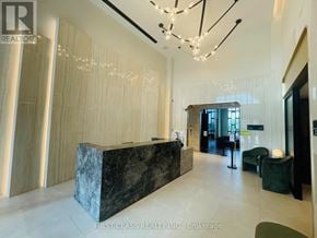 Oakville (Jm Joshua Meadows) condo for rent - A reception area with a marble counter and a chandelier.