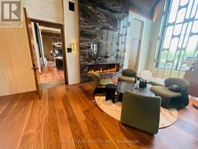 Oakville (Jm Joshua Meadows) condo for rent - A living room with a fireplace and a large mirror on the wall.