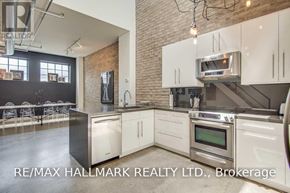 Toronto (Dovercourt-Wallace Emerson-Junction) townhouse for rent - A modern kitchen with white cabinets and stainless steel appliances.