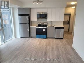 Burlington (Alton) condo for rent - A kitchen with a refrigerator, stove, and microwave.