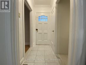 Toronto (Keelesdale-Eglinton West) apartment for rent - A hallway with a white door and a window above it.