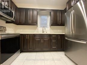 Toronto (Keelesdale-Eglinton West) apartment for rent - A kitchen with brown cabinets and a stainless steel refrigerator.