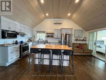 Kawartha Lakes (Carden) apartment for rent - A kitchen with a table and chairs in the middle of it.