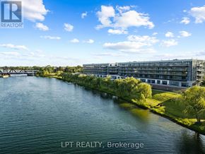 Welland (Broadway) condo for rent - A river flows through a city with a bridge in the background and a building with the sign LPT REALTY, Brokerage.