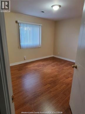 Windsor condo for rent - A room with wooden flooring and a window with blinds.